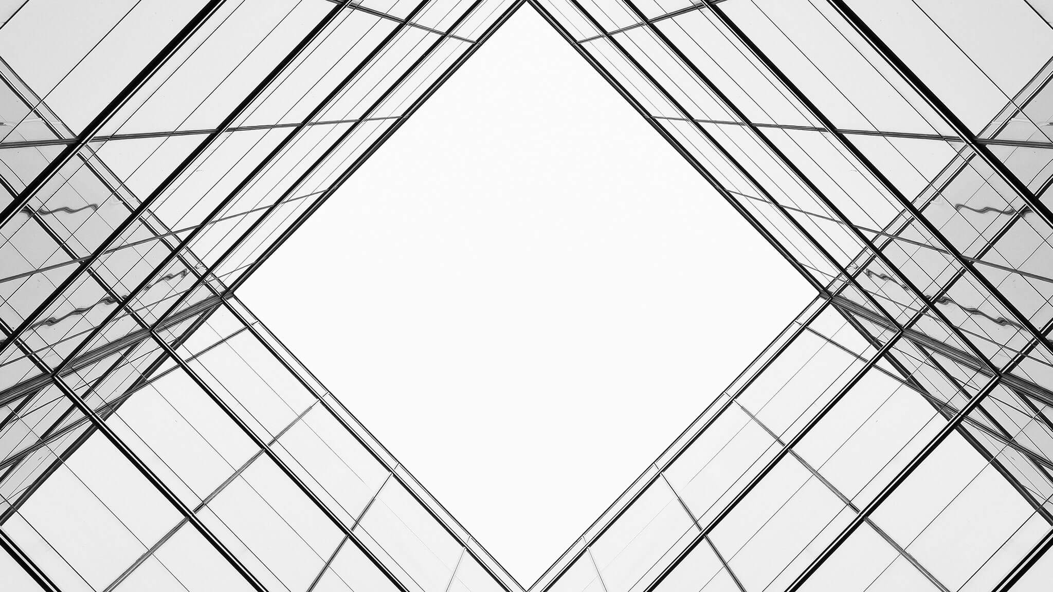Worm's eye view shot looking up through glass atrium