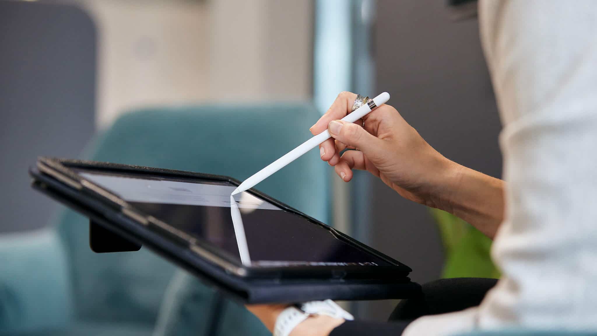 Alternate close up of woman's hands using stylus and tablet