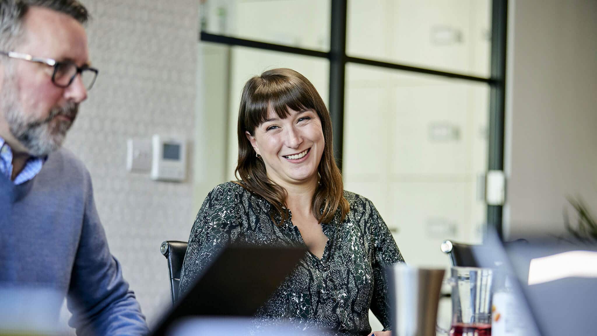 Nikki Rees smiling at colleague off camera
