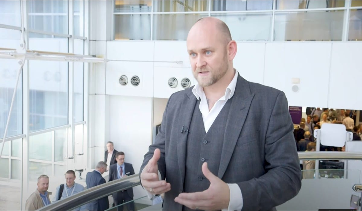 Client in grey suit giving testimonial